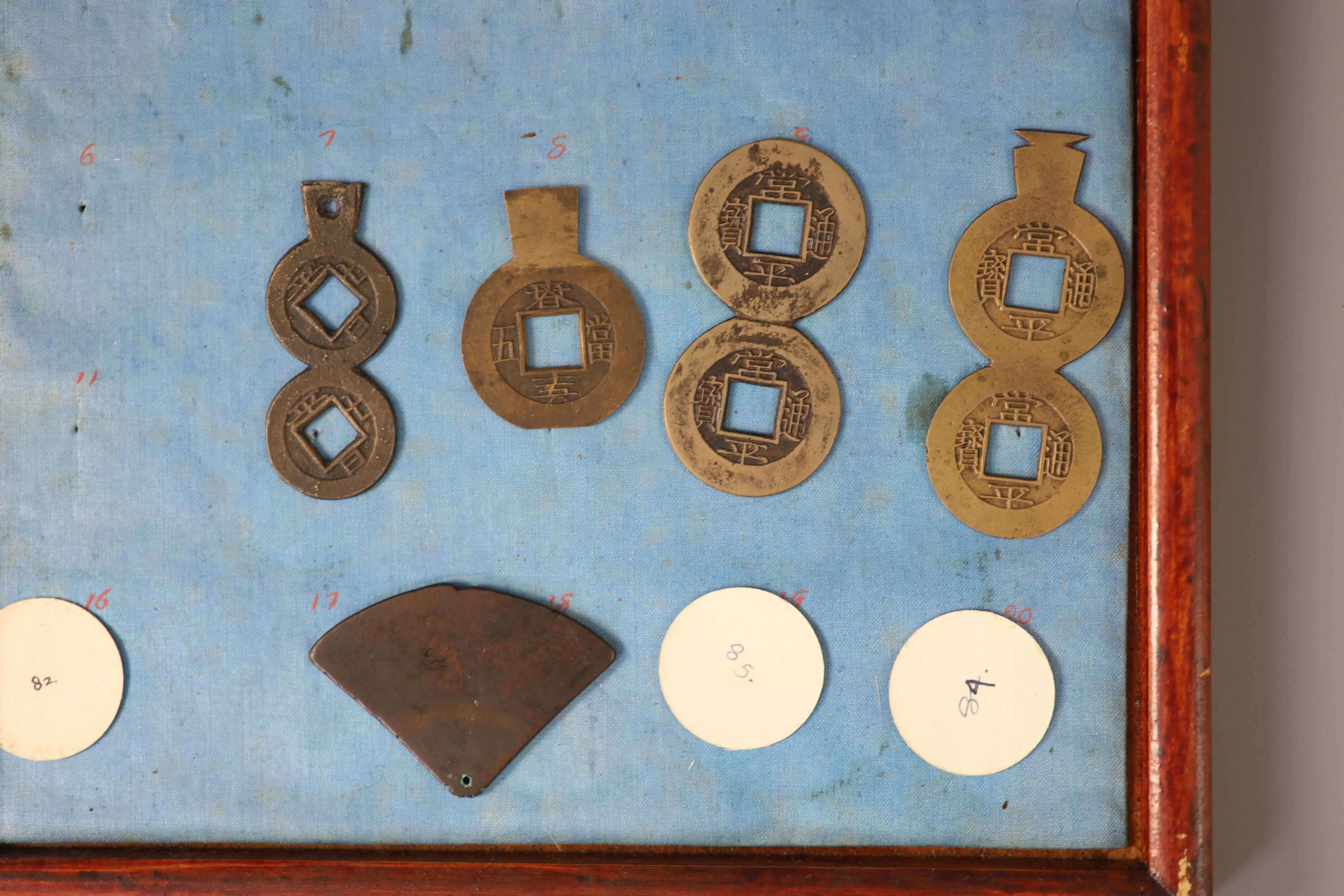 A group of 99 Korean bronze and metal amulets or charms, 19th/20th century